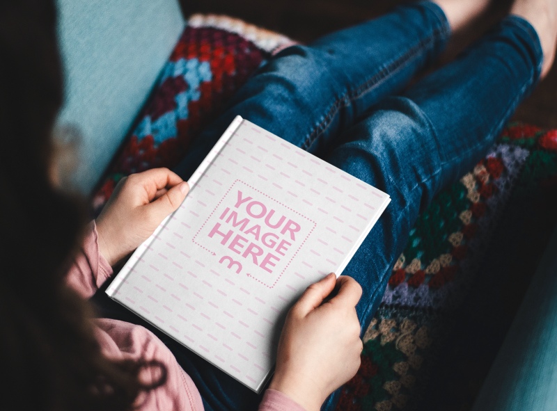 6x9 Hardcover Book on Woman's Lap Mockup Generator preview image