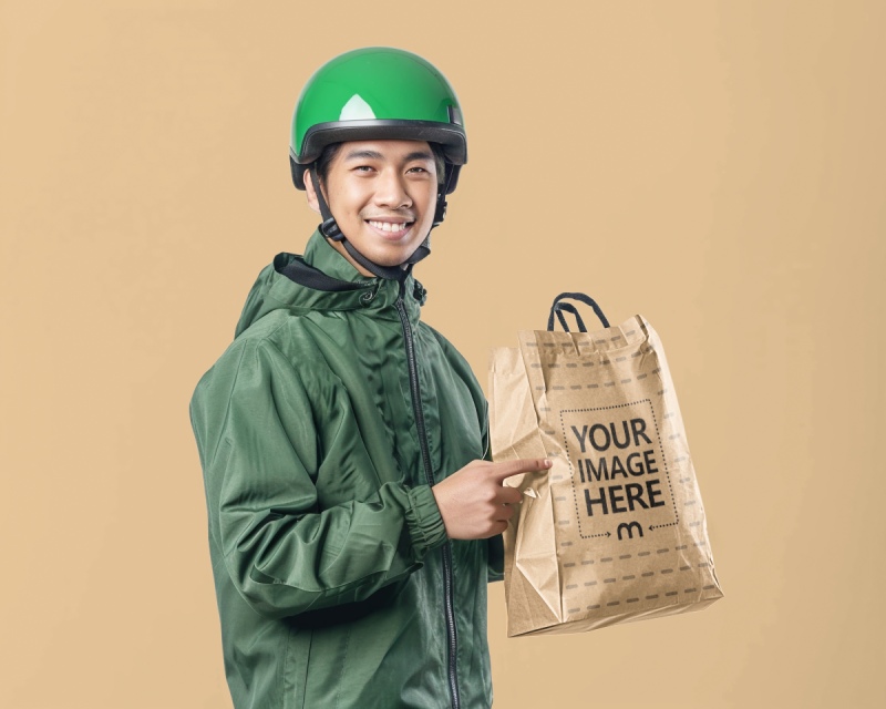 Craft Paper Bag Mockup Held by Delivery Person for Grocery Ads preview image