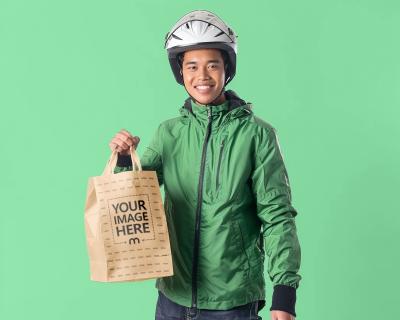 Craft Paper Bag Mockup Held by Delivery Person