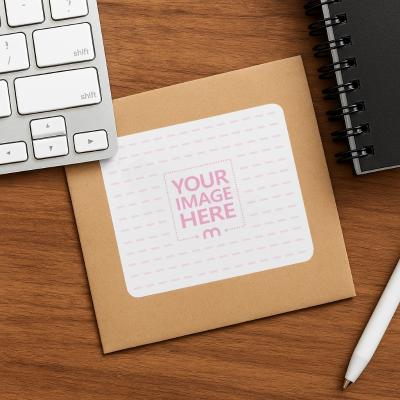 Mail Sticker Mockup on Cardboard Mail with Notebook and Pen