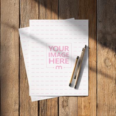 A4 Paper Mockup Top View on Wooden Background