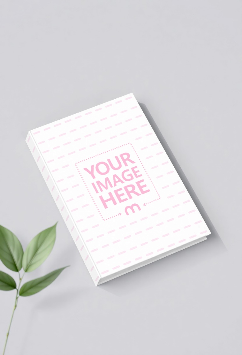 Book Mockup Flatlay with Leaf on Gray Background preview image