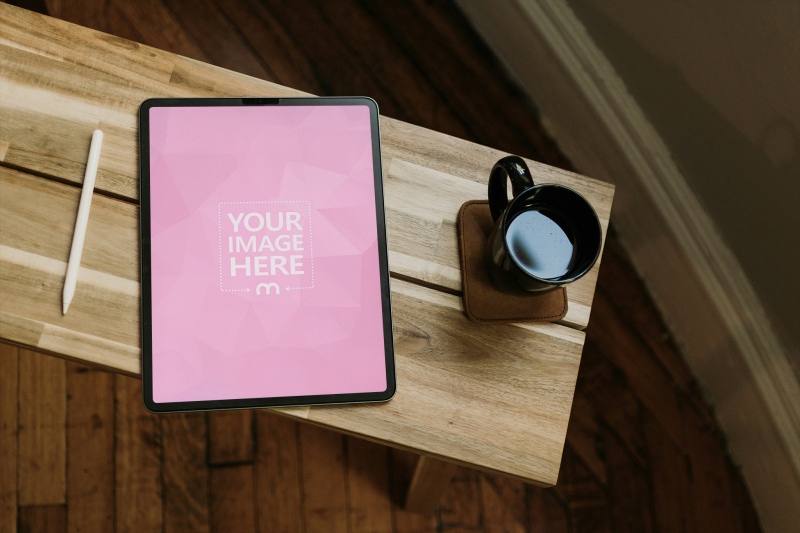 Top View iPad Mockup on Wooden Table for Ad and UI Display preview image