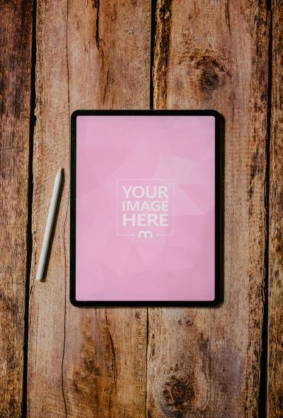 Top View of iPad Mockup on Wooden Floor for Minimal Design Display