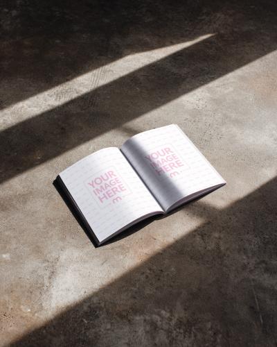 Open Book Page Mockup on Concrete Floor with Natural Light
