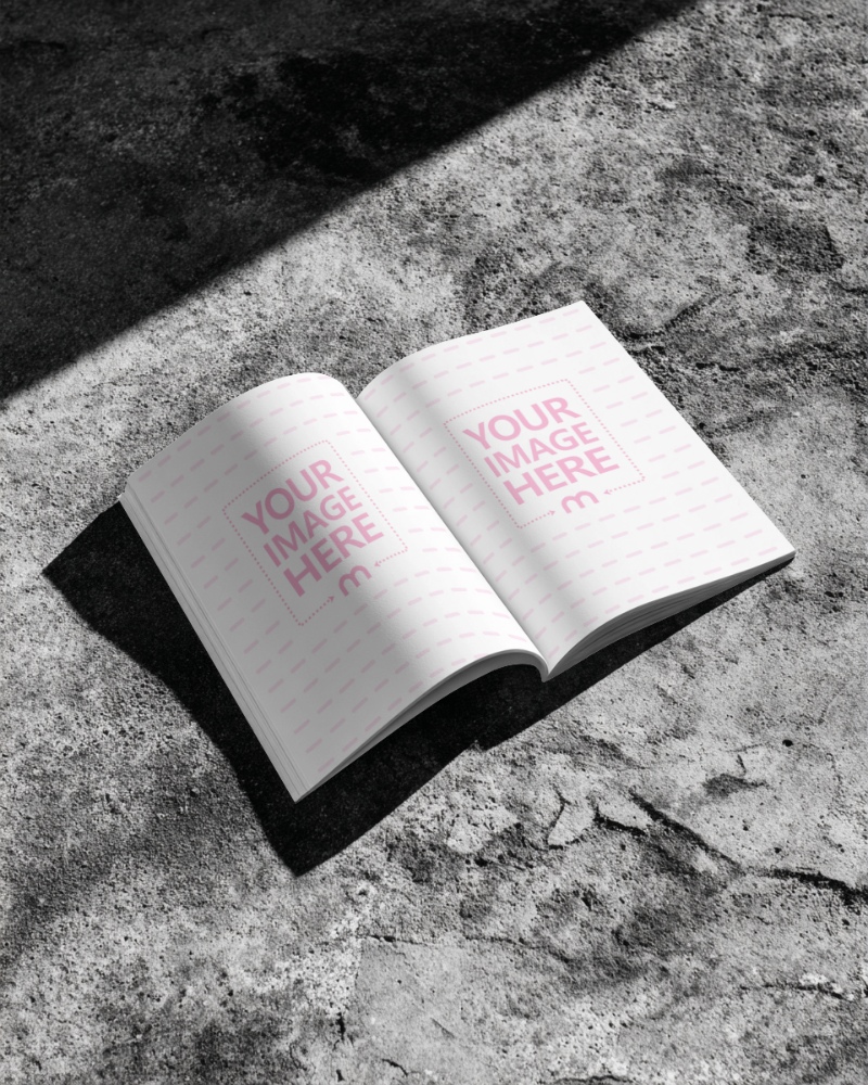 Open Book Page Mockup on Concrete Floor for Bright Editorial Display preview image