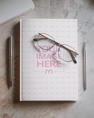 Book Cover Mockup on Marble Floor with Pens for Professional Writers