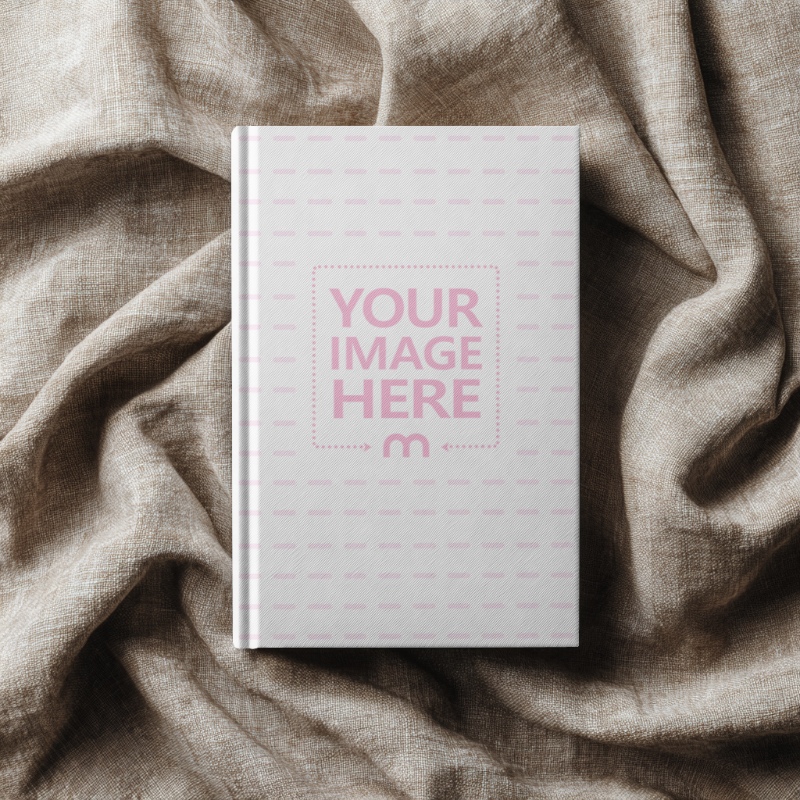 Top View of Book Cover Mockup on Elegant Clothing preview image
