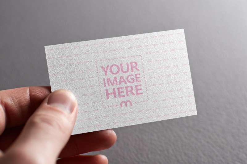 Business Card Mockup Held by Hand with Gray Background preview image