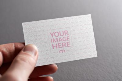 Business Card Mockup Held by Hand with Gray Background