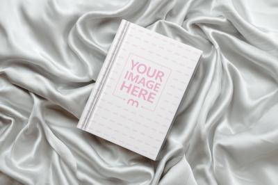 Book Cover Mockup on Crumpled Silver Cloth for Romantic Book Covers