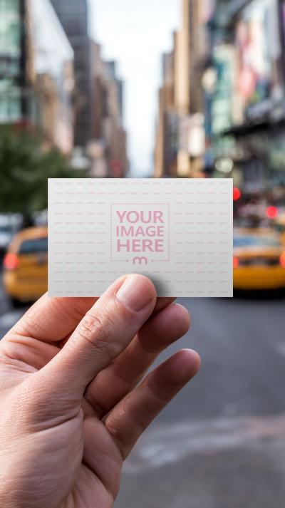 Business Card Mockup in Hand with City Background
