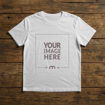 Kids T-Shirt Mockup on Wooden Table - Top View
