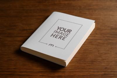 Paperback Book Cover Mockup Standing on Wooden Table