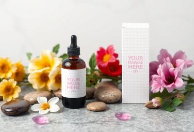 Dropper Bottle and Box Mockup with Flowers for Perfume Branding