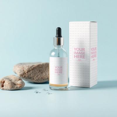 Bottle Label and Box Mockup with Rocks on Light Blue Background