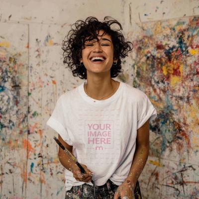 T-Shirt Mockup with Woman in Paint Studio Holding Brush