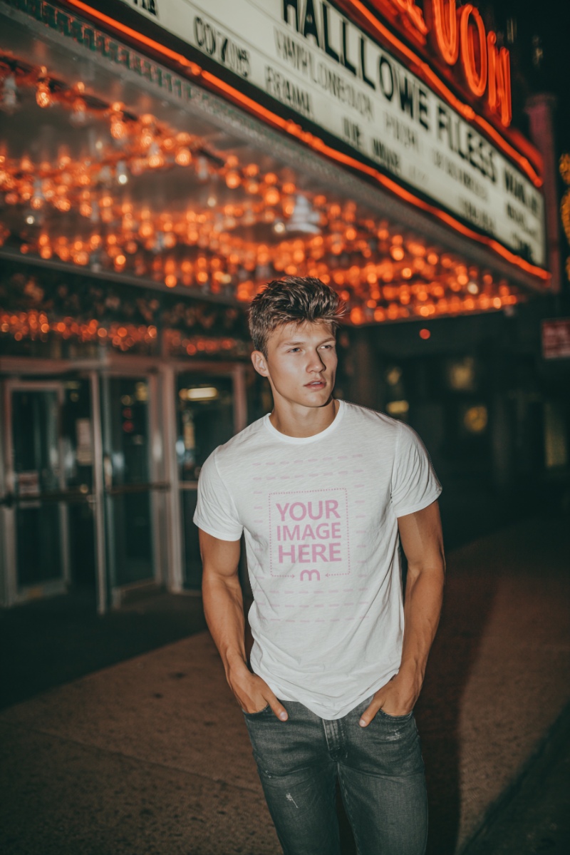 T-Shirt Mockup with Man Posing under Lights for Halloween Mood T-Shirt Mockup with Man Posing under Lights for Halloween Mood preview image