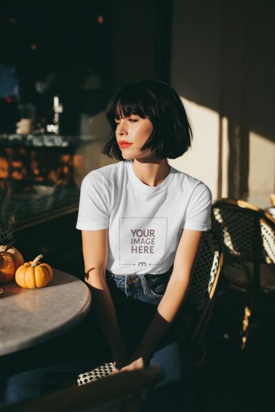 T-Shirt Mockup on Woman Sitting in Café Scene
