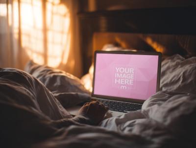 Laptop Screen Mockup with Hand on Keyboard over Bedcover