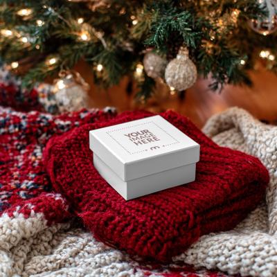 Gift Box Label Mockup in Front of Christmas Décor