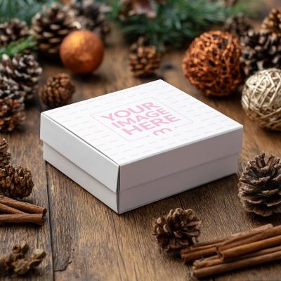 Square Box Mockup on Table with Festive Decor for Christmas Packaging