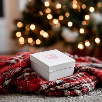 Gift Box Mockup on Red Blanket with Christmas Décor for Branding
