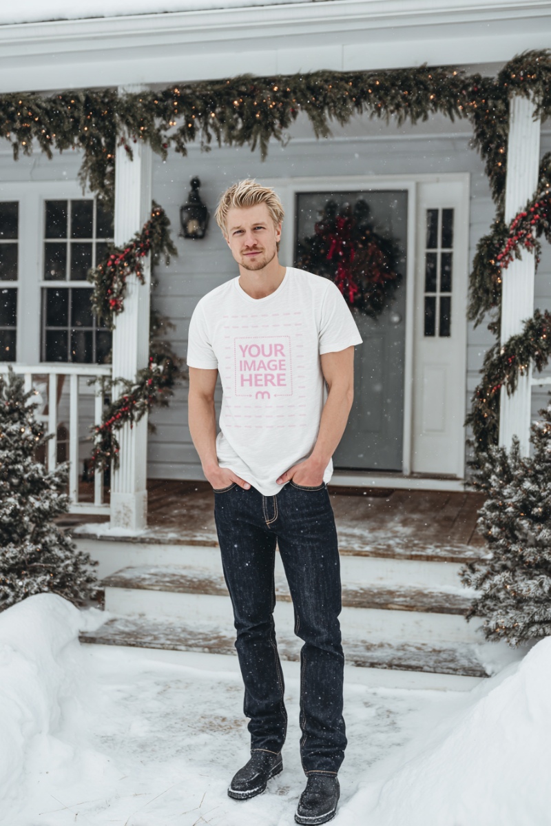 T-Shirt Mockup with Man Posing in Outdoor Snowy Christmas Tree Scene preview image