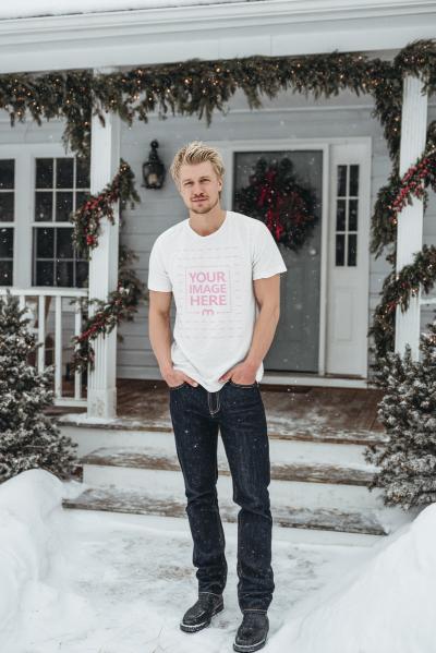 T-Shirt Mockup with Man Posing in Outdoor Snowy Christmas Tree Scene
