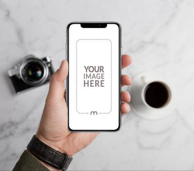 iPhone Mockup Generator in Hand with Retro Camera in the Background