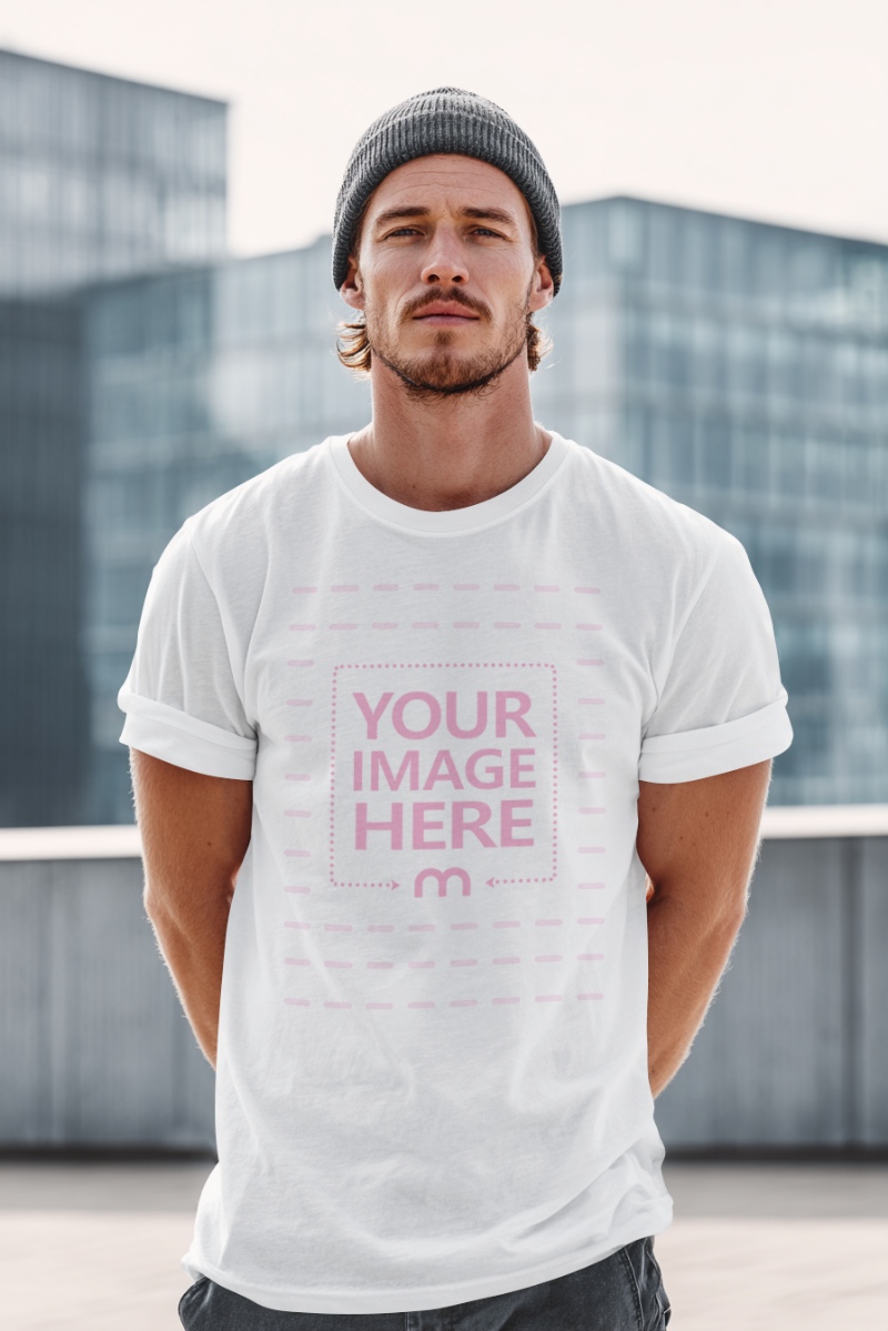 T-Shirt Mockup with Man and Tall Buildings in City Background preview image
