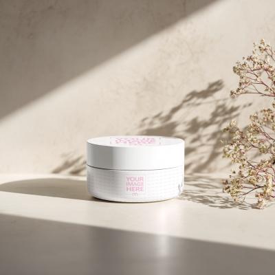 Cosmetics Bottle Mockup with Orange Hue and Small Plant Accent