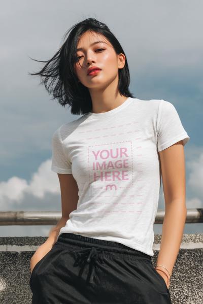 T-Shirt Mockup with Asian Woman Posing in Simple Outdoor Setting