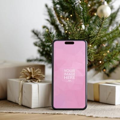 iPhone Mockup with Gift Box and Mini Tree in Bright Holiday Setup