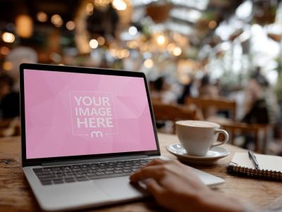 Laptop Mockup on Table in Cozy Café Interior with Warm Décor