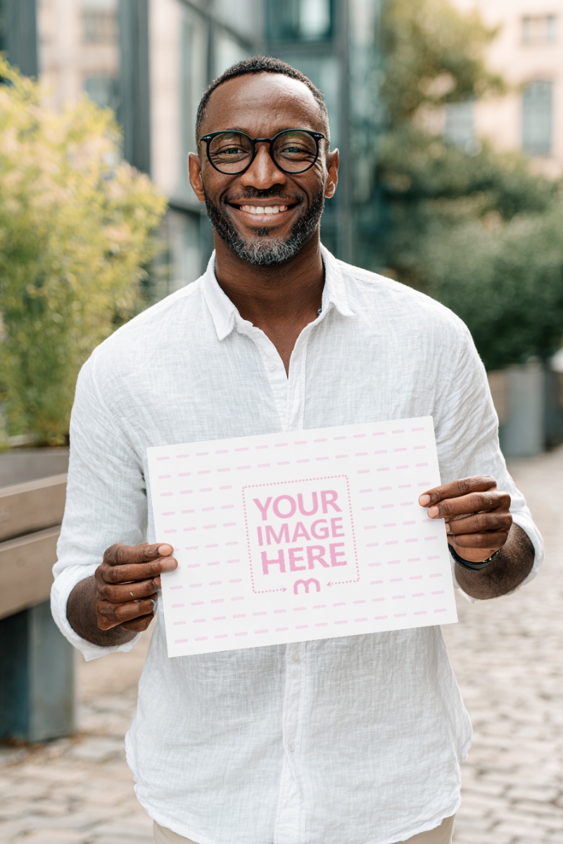 Paper Sign Mockup Held with Black Man Outdoors preview image