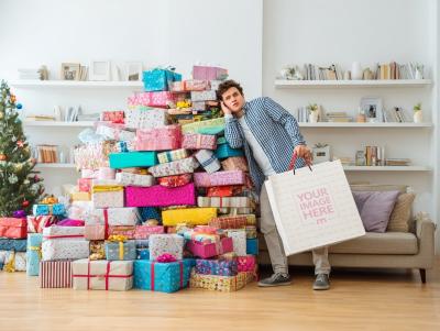 Paper Tote Bag Mockup with Man Leaning on Gift Boxes