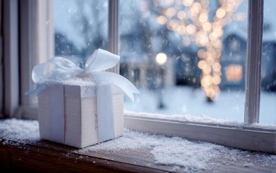 Gift Box Mockup on Windowsill with Falling Snow and Soft Lights