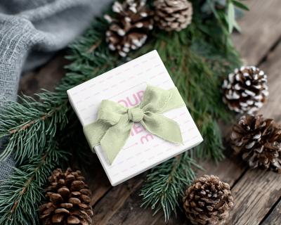 Gift Box Mockup Among Pinecones and Branches on Wooden Table