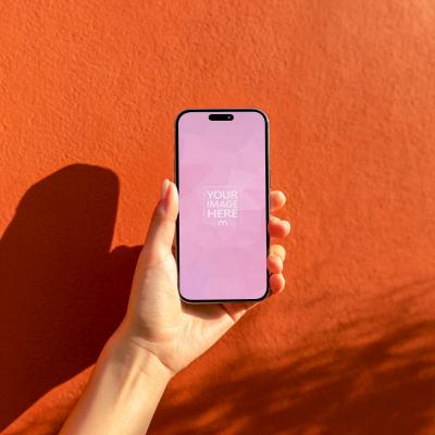 Smartphone Mockup in Hand with Orange Wall Background