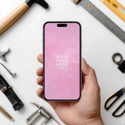 Smartphone Mockup Held Above Workbench with Tools