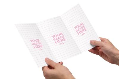Trifold Brochure Mockup in Hands on Isolated Background