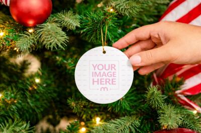 Round Christmas Ornament Mockup Hanging on Tree in Festive Scene