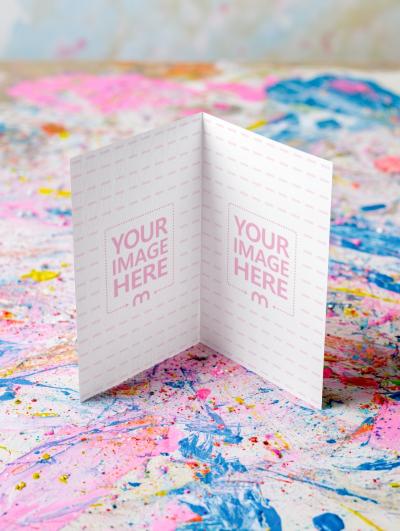 Open Bifold Card Mockup on Colorful Surface in Artistic Workspace