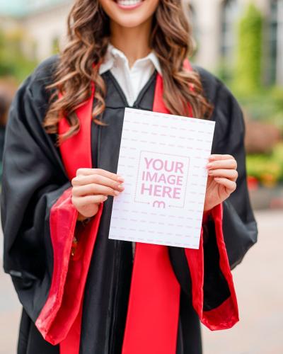 Poster Mockup Held by Graduate in Academic Gown