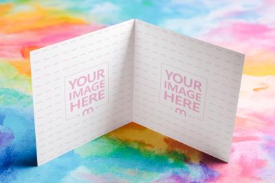 Opened Bifold Card Mockup in Symmetrical Layout on Colorful Surface