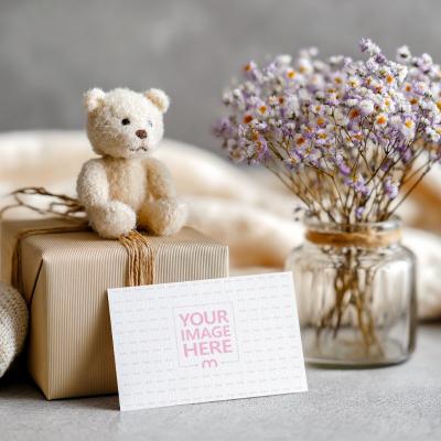 Card Mockup Resting Against Wrapped Gift