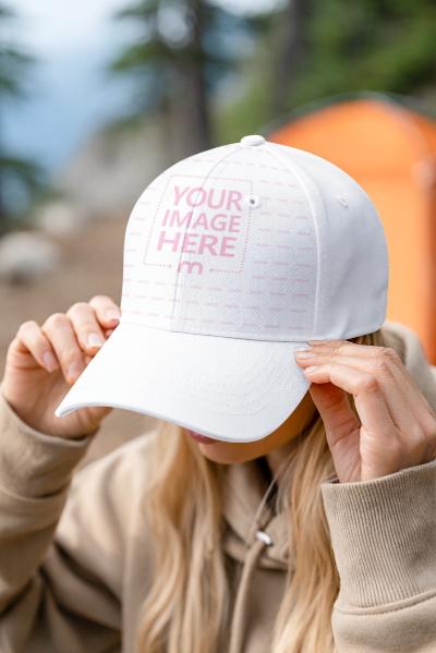 Cap Mockup Worn by Model Adjusting Brim Outdoors