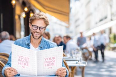 Fashion Magazine Mockup Read by Man at Outdoor Café