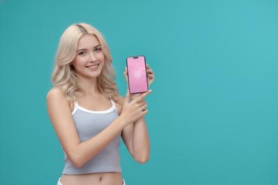 Smartphone Mockup Presented by Blonde Woman in Studio